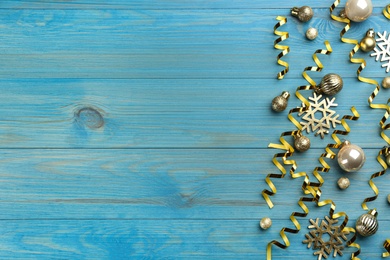 Photo of Flat lay composition with serpentine streamers and Christmas decor on blue background. Space for text