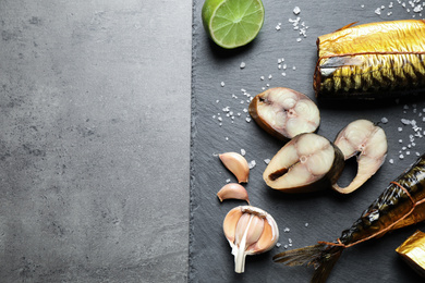 Photo of Tasty smoked fish on grey table, top view. Space for text