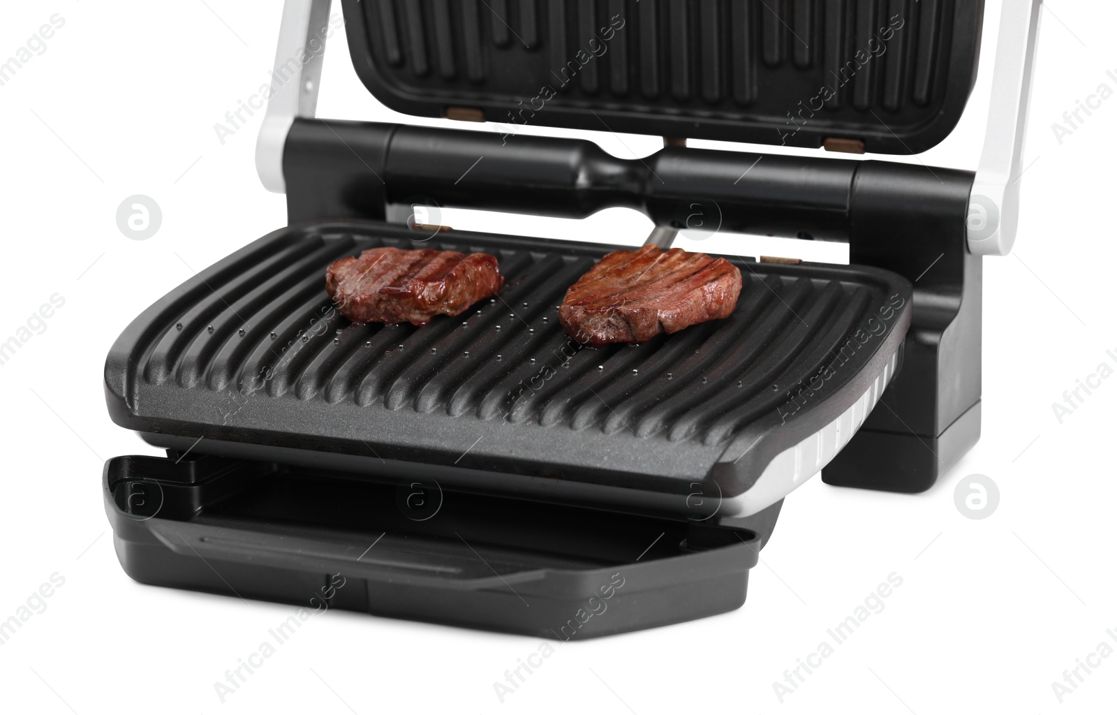 Photo of Electric grill with tasty meat steaks isolated on white
