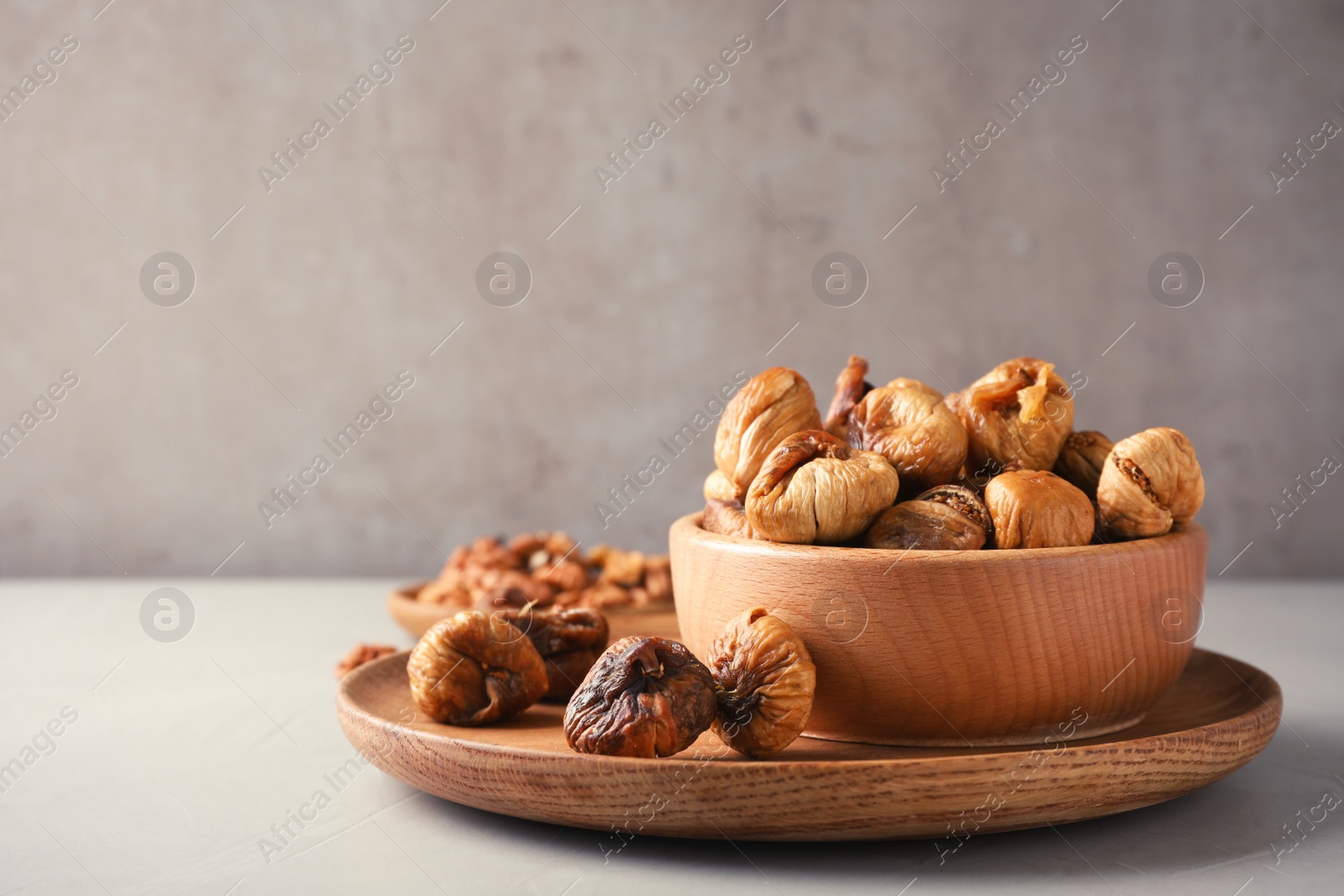 Photo of Composition with dried figs on grey table. Space for text