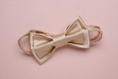 Photo of Stylish bow tie on beige background, top view