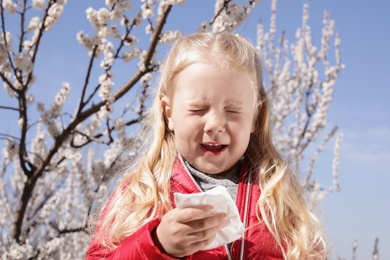 Photo of Little girl suffering from seasonal allergy outdoors