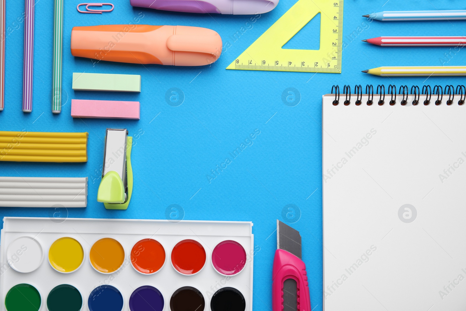 Photo of Different school stationery on light blue background, flat lay with space for text. Back to school