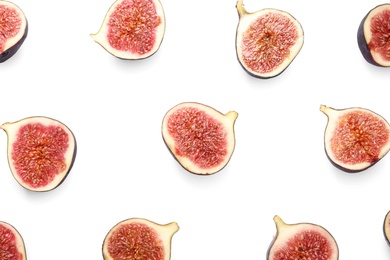 Cut ripe figs on white background, top view