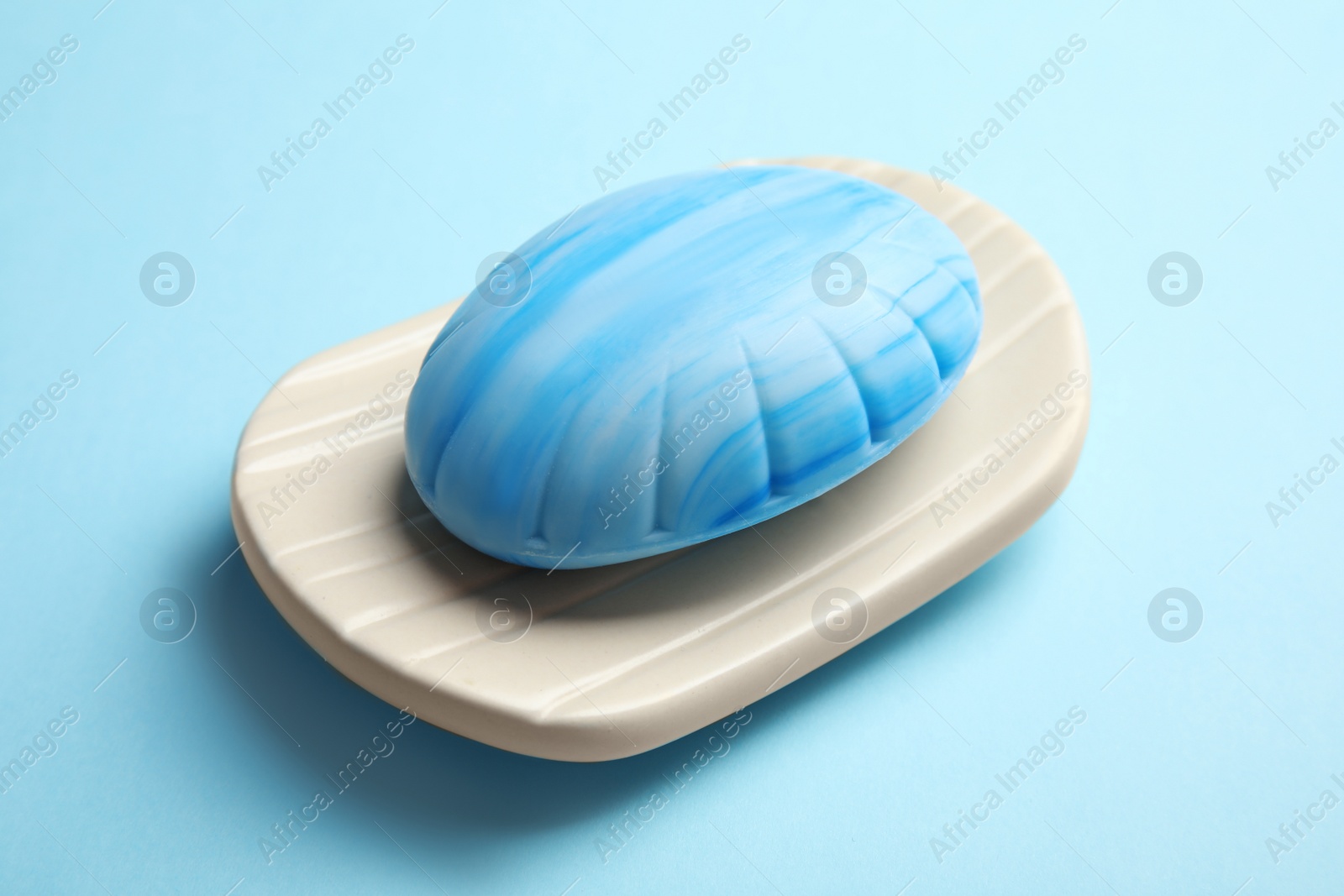 Photo of Holder with soap bar on color background