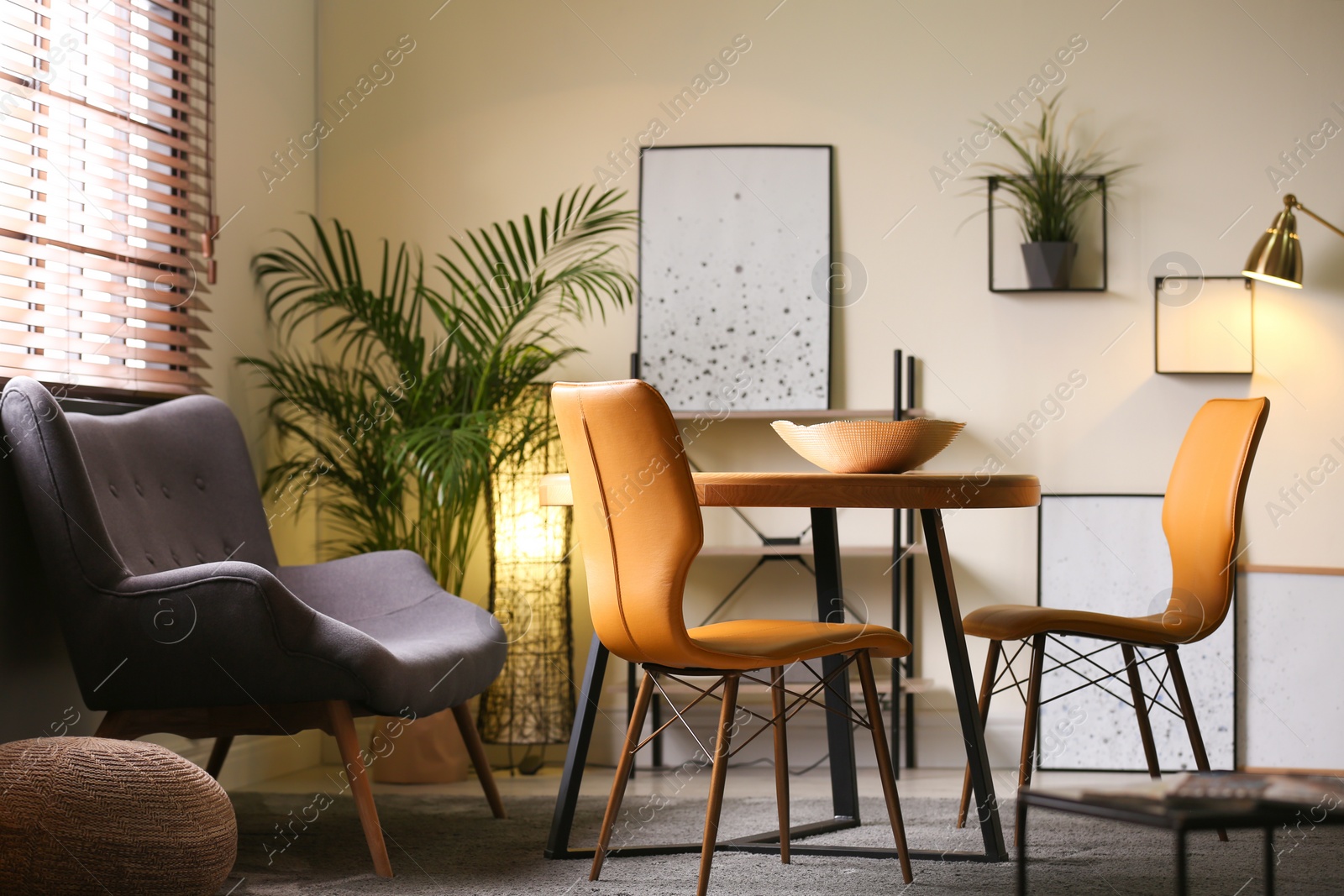 Photo of Stylish dining room interior with modern table set and window blinds