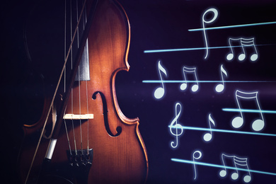Image of Classic violin and music notes on dark background