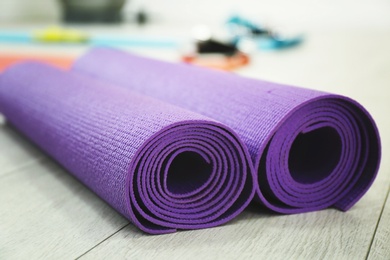 Photo of Rolled yoga mats indoors, closeup. Physiotherapy center