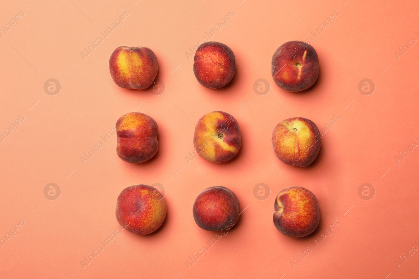 Photo of Sweet juicy peaches on orange background, flat lay