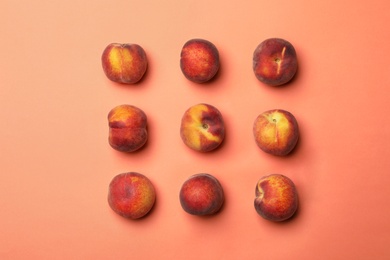 Photo of Sweet juicy peaches on orange background, flat lay