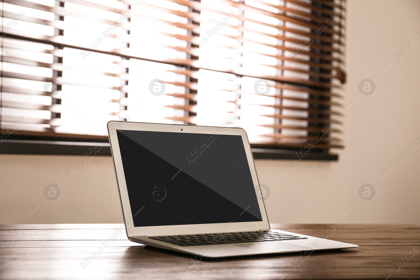 Image of Modern laptop on wooden table indoors. Comfortable workplace 