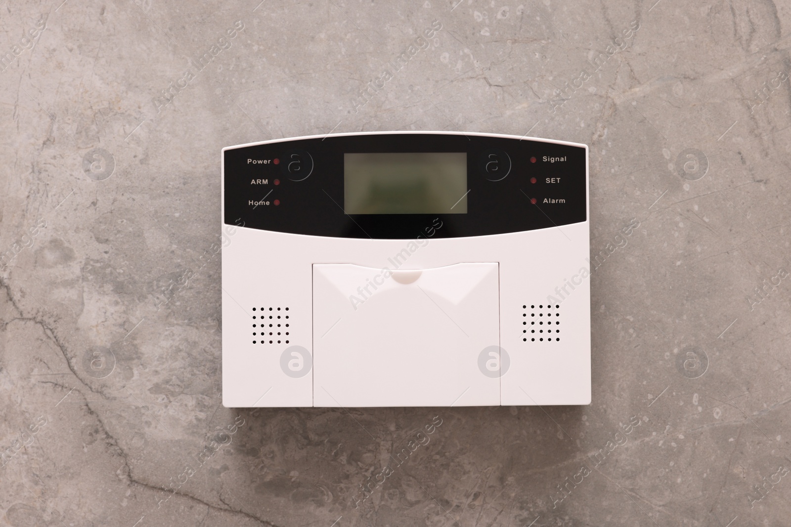 Photo of Home security alarm system on grey wall