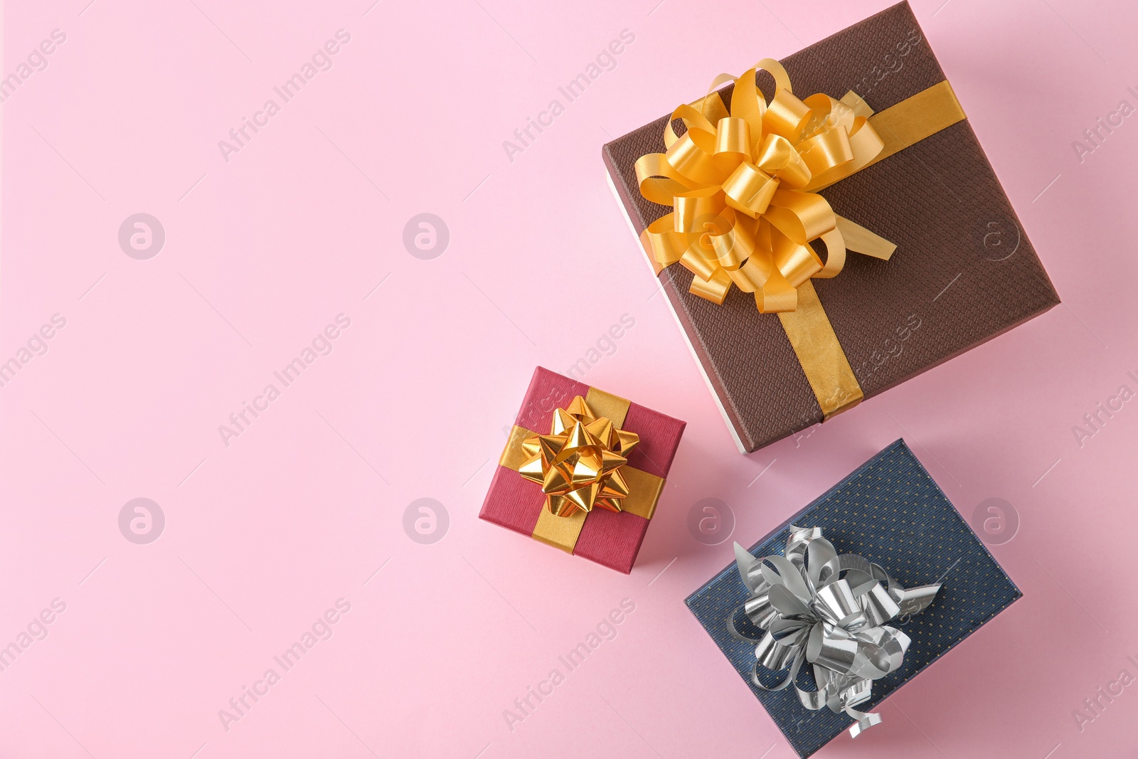 Photo of Flat lay composition with beautiful gift boxes on pink background. Space for text