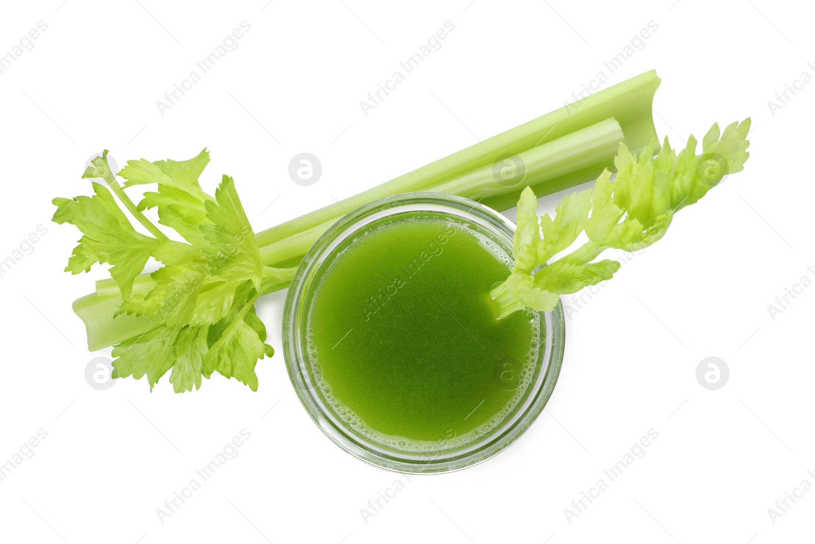 Photo of Glass of celery juice and fresh vegetable on white background, top view