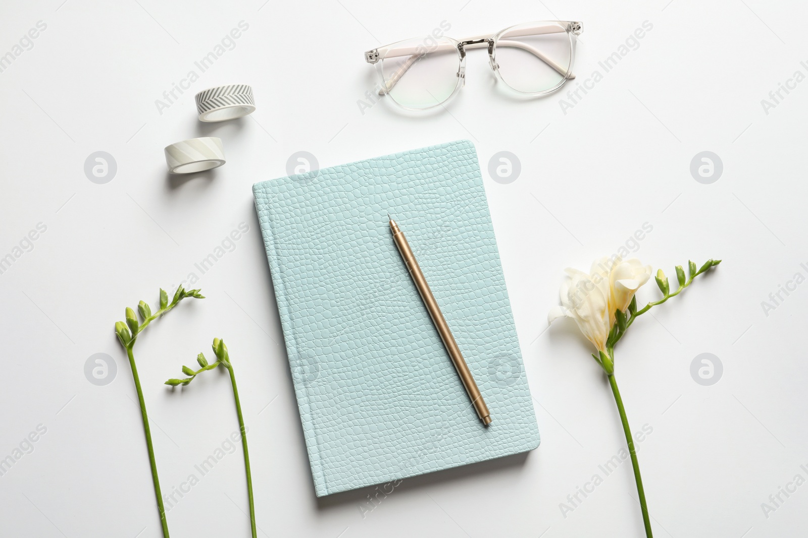 Photo of Flat lay composition with book, glasses and flowers on white background