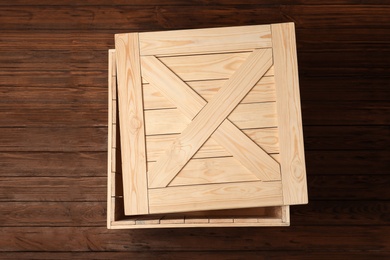 Photo of Wooden crate with lid on color background, top view