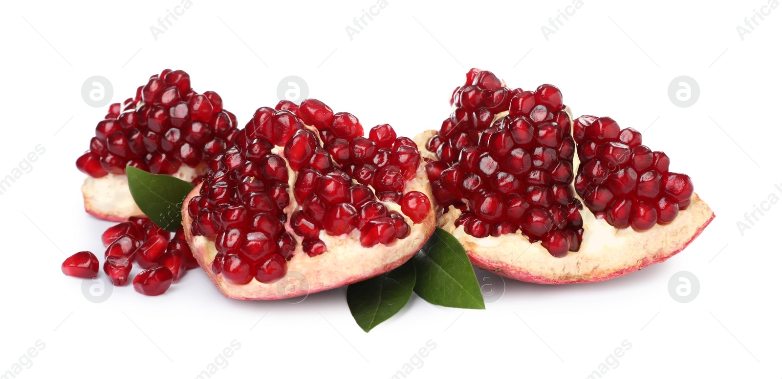 Photo of Pieces of ripe pomegranate with green leaves on white background