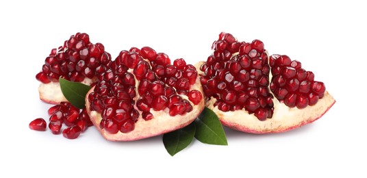 Pieces of ripe pomegranate with green leaves on white background