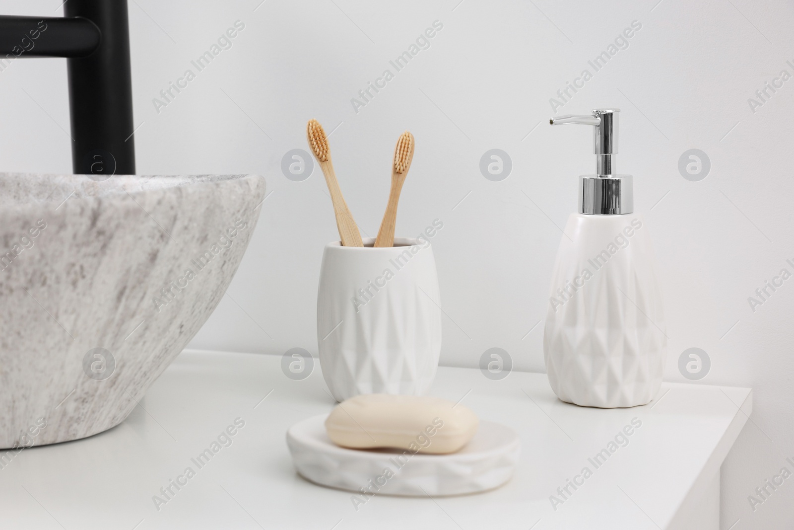 Photo of Different bath accessories and personal care products on white countertop in bathroom