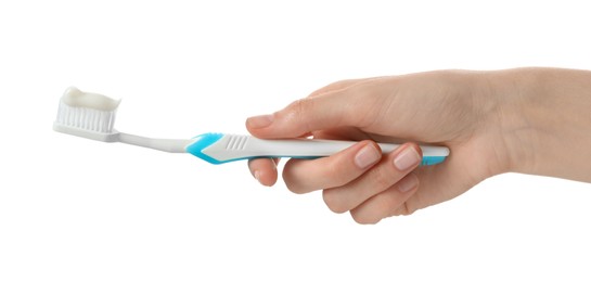 Woman holding toothbrush with paste on white background, closeup