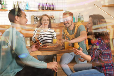 Image of Group of friends having fun party with delicious pizza in cafe, bokeh effect