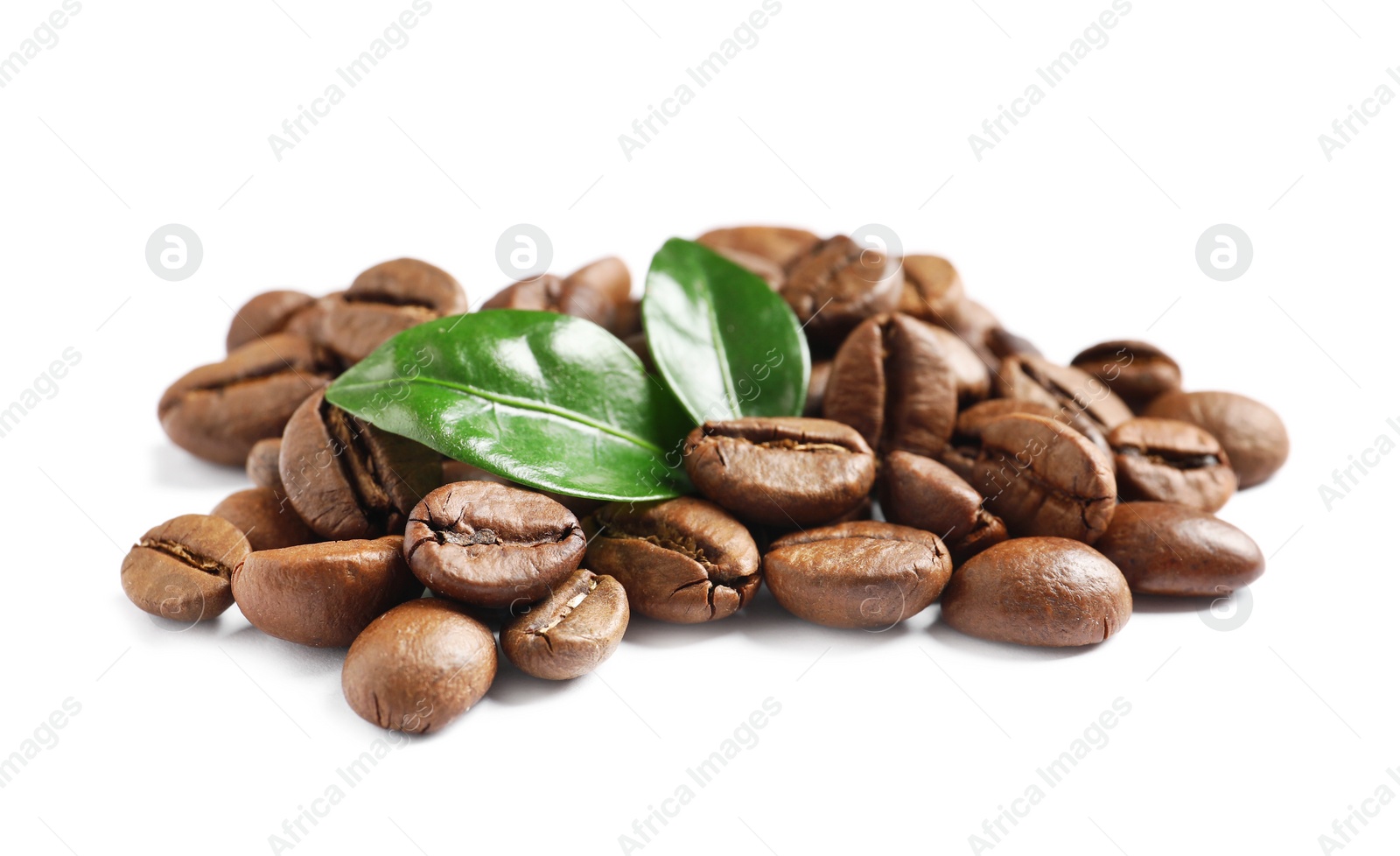 Photo of Roasted coffee beans and fresh green leaves on white background