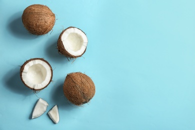 Photo of Flat lay composition with coconuts on color background. Space for text