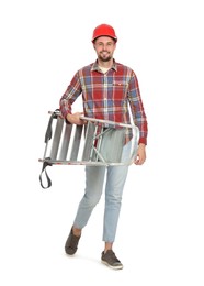 Photo of Young handsome man in hard hat holding metal ladder on white background
