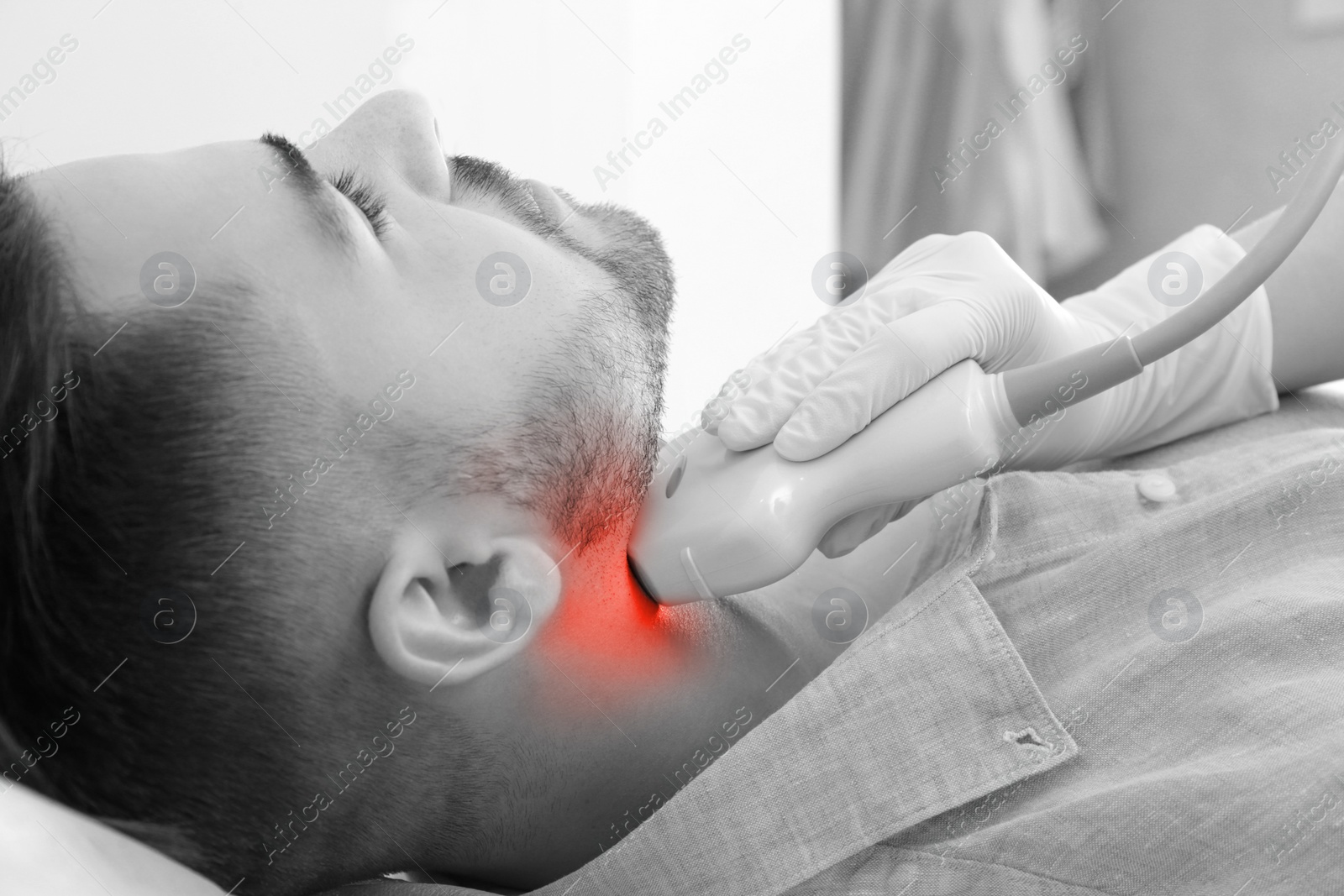 Image of Endocrine system. Medical specialist conducting ultrasound examination of patient's thyroid gland at hospital, closeup. Black and white effect