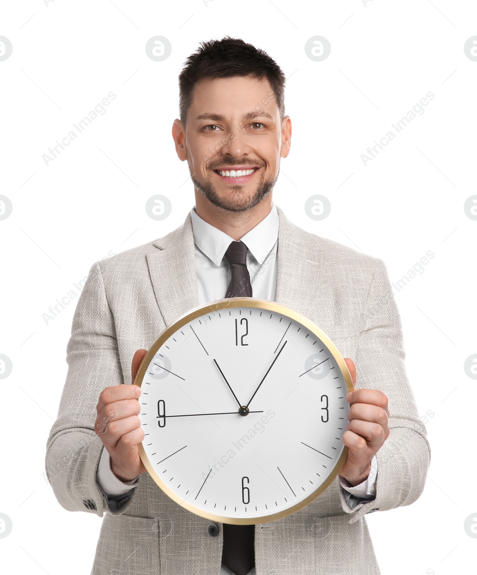 Photo of Happy businessman holding clock on white background. Time management