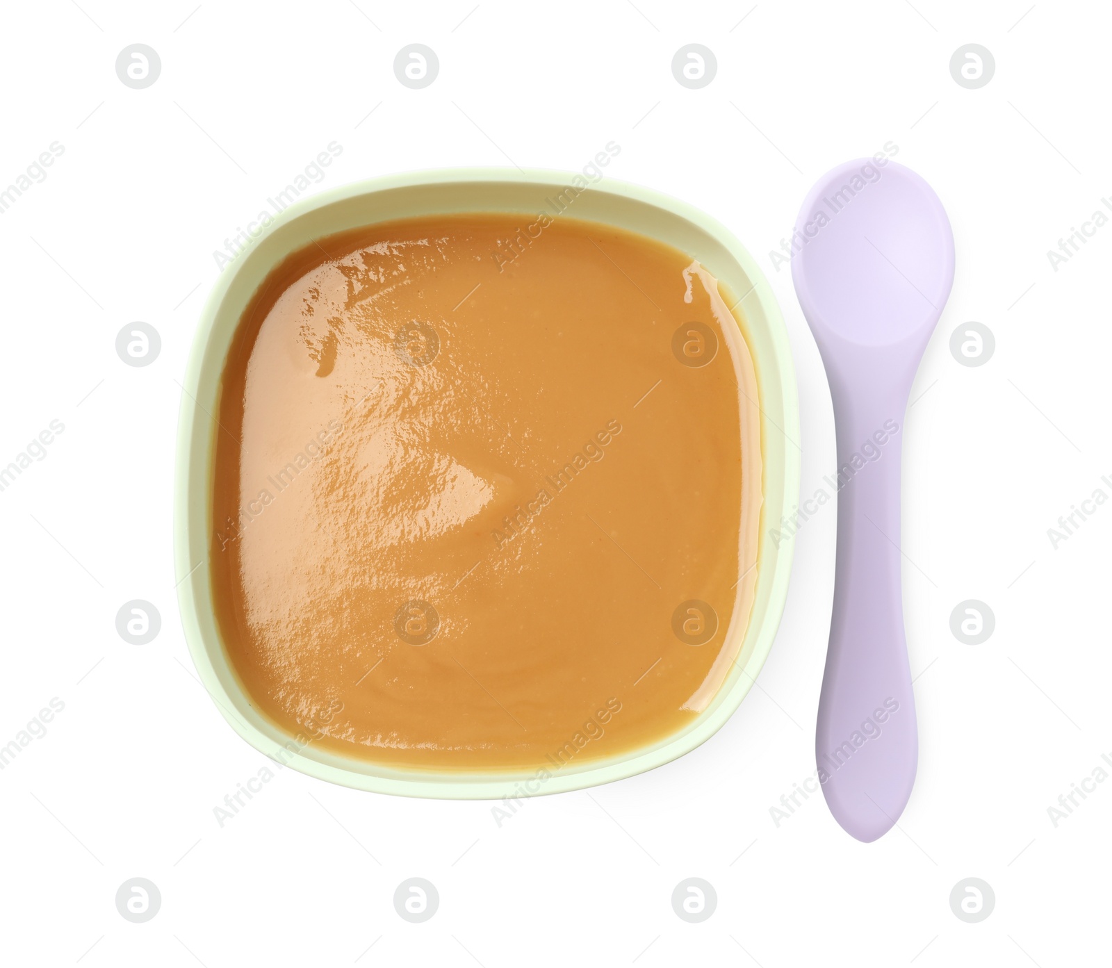 Photo of Tasty baby food in bowl and spoon isolated on white, top view