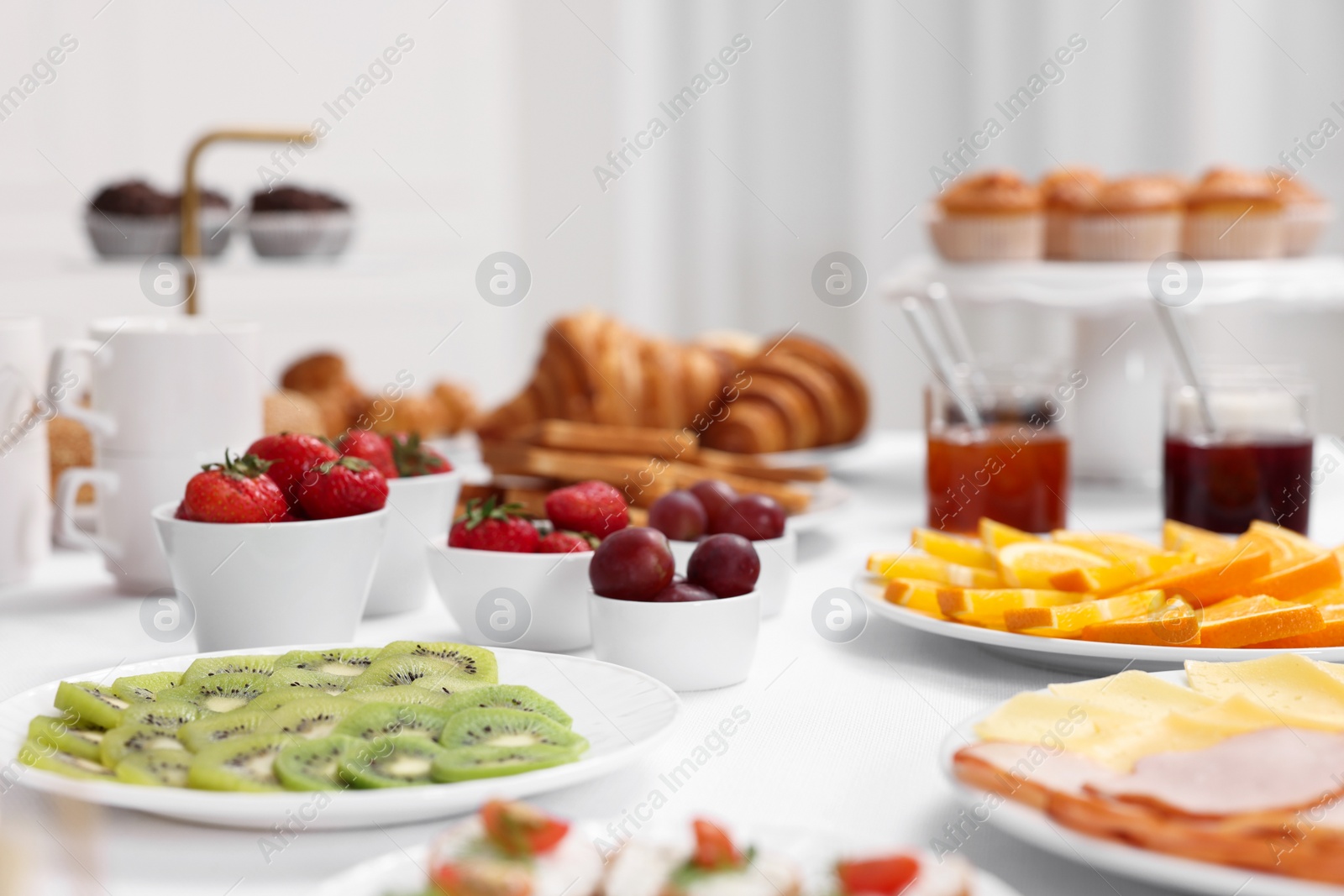 Photo of Different meals served on white table indoors, selective focus. Buffet menu