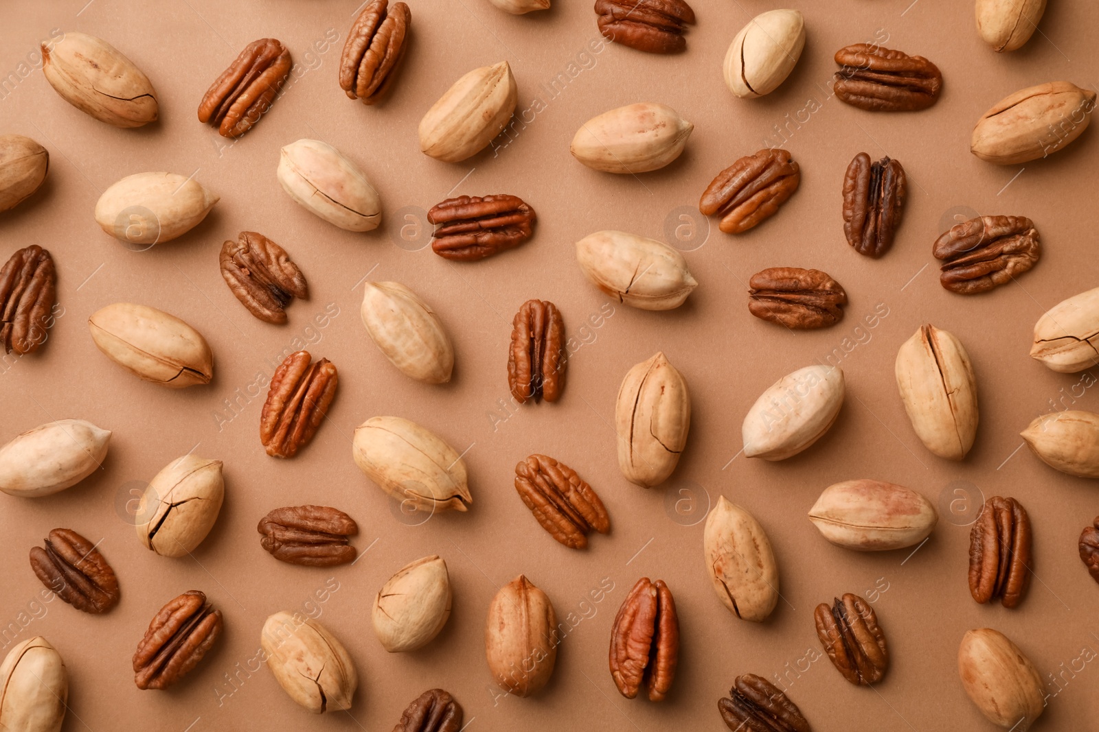 Photo of Composition with ripe pecan nuts on color background, flat lay