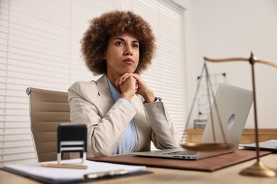 Photo of Notary with laptop at workplace in office