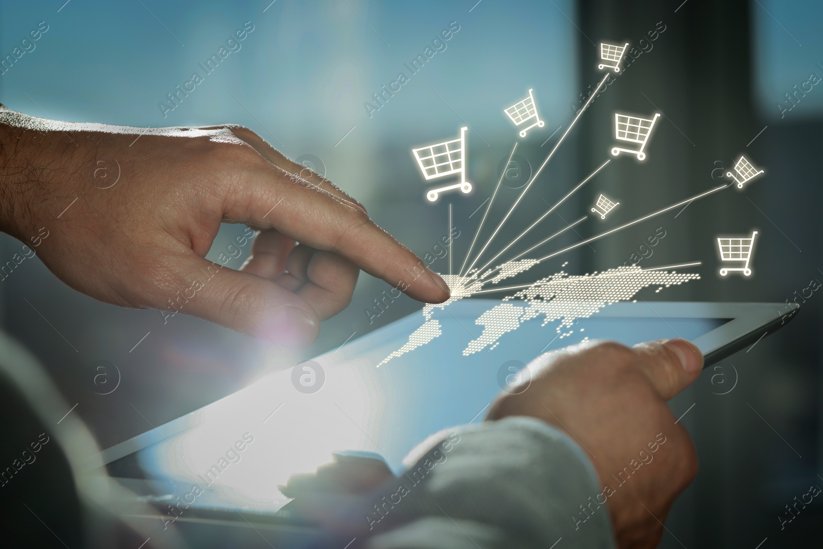 Image of Man using tablet for online purchases on blurred background, closeup. Illustration of world map and shopping cart icons above device screen