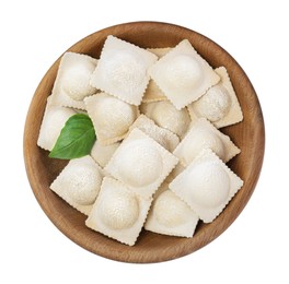 Uncooked ravioli and basil in wooden bowl on white background, top view