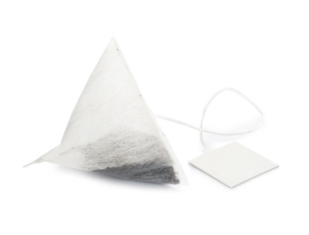 Photo of Unused pyramid tea bag with tag on white background