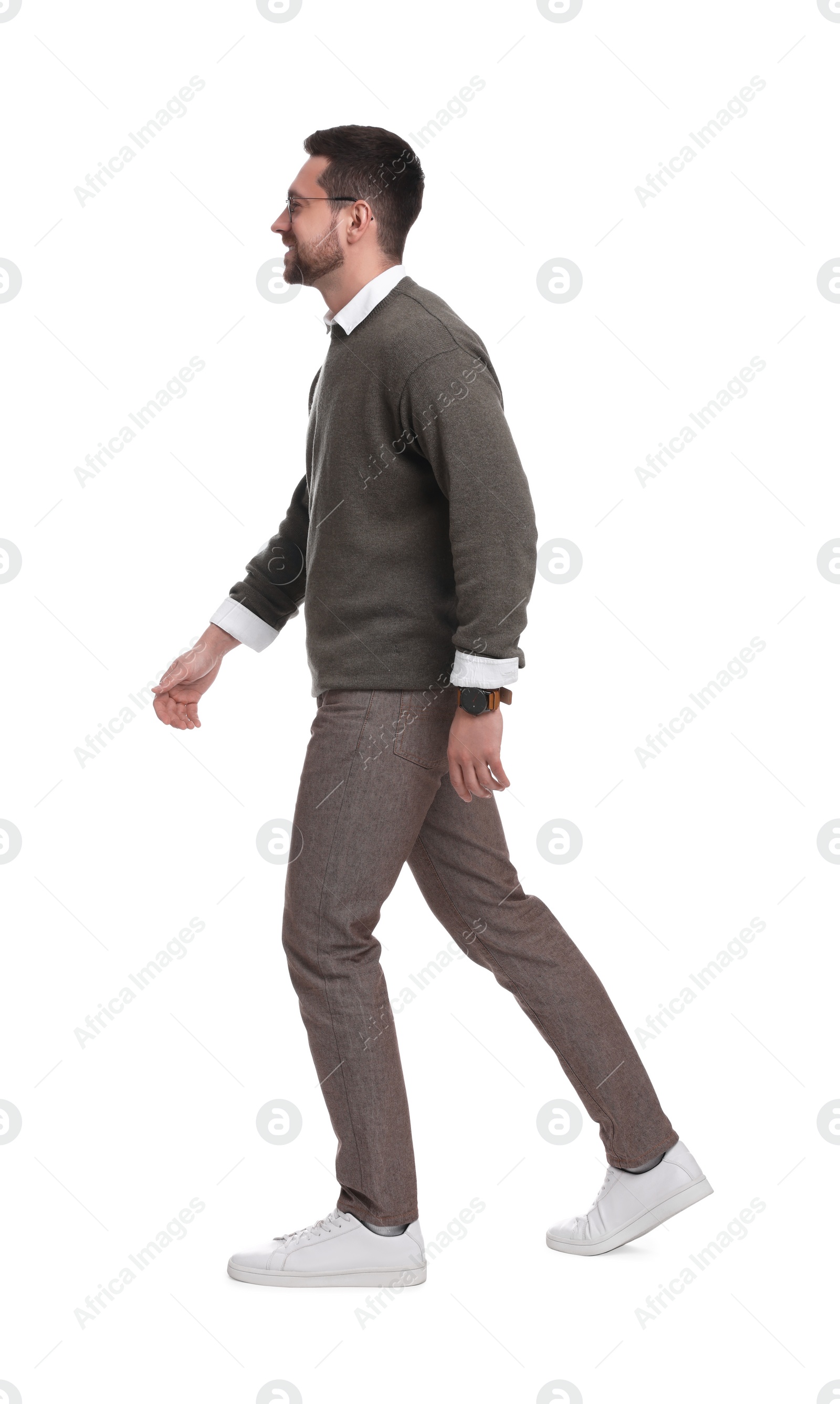 Photo of Handsome bearded businessman in eyeglasses walking on white background