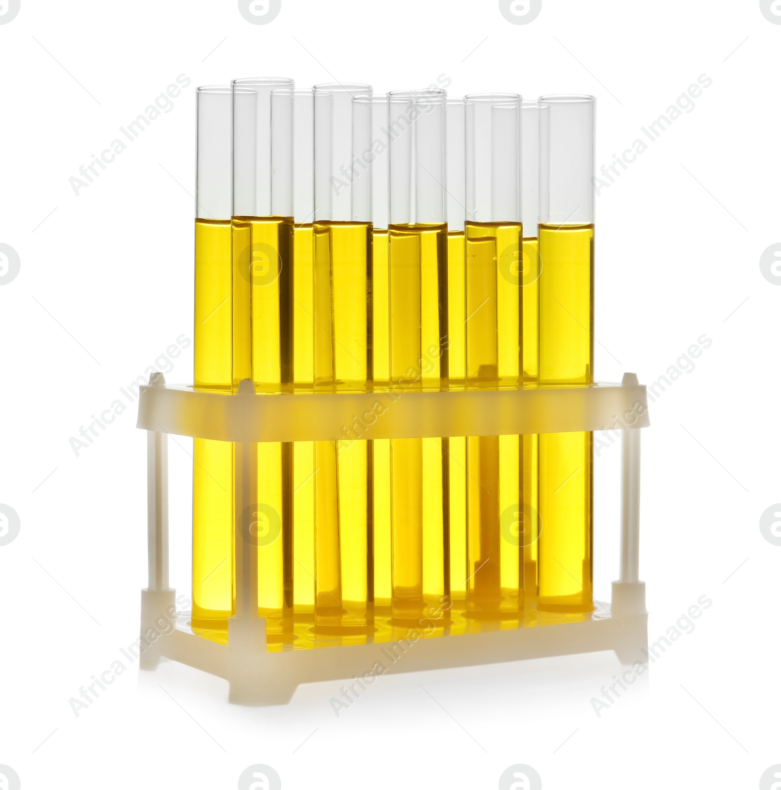 Photo of Test tubes with yellow liquid on white background