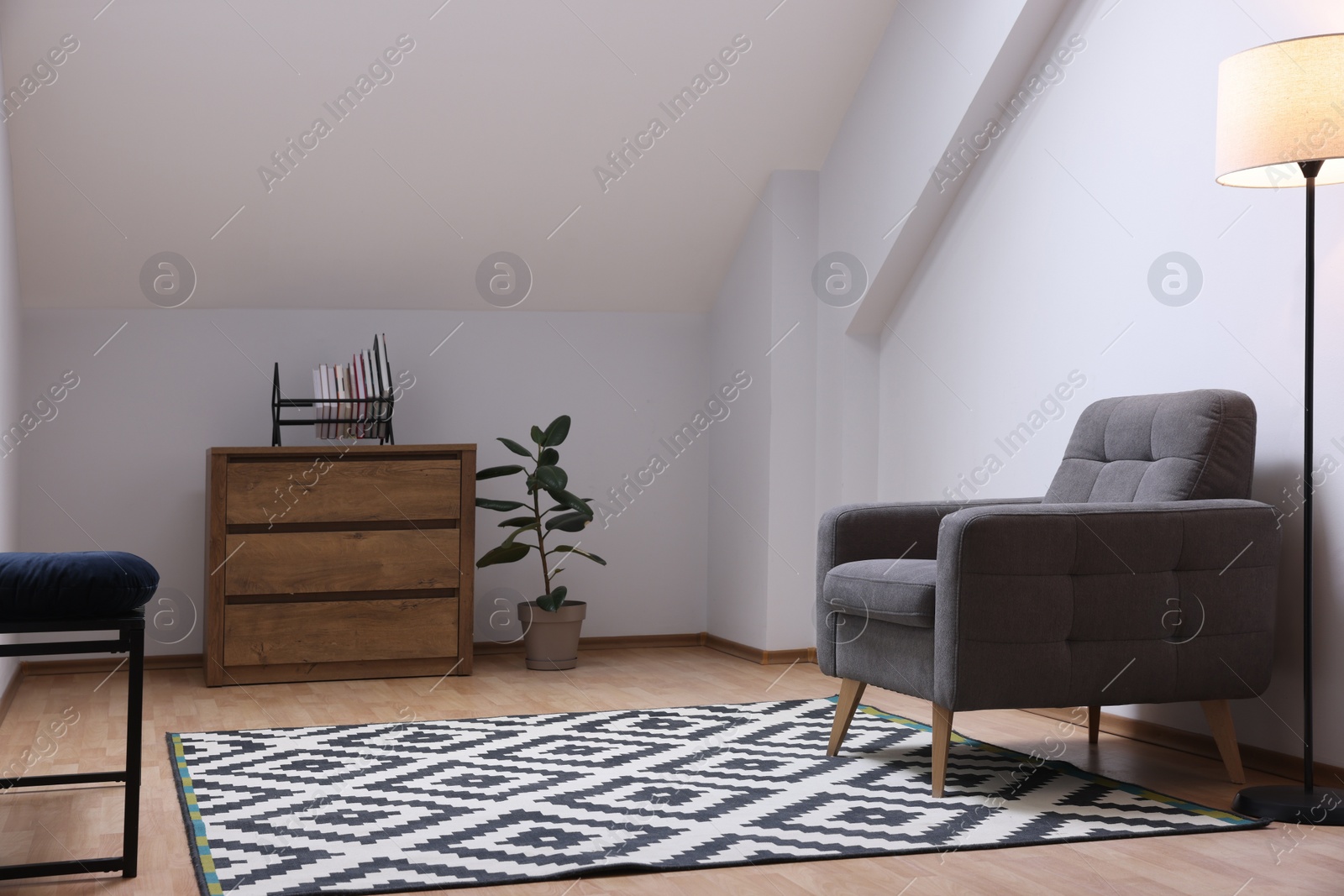 Photo of Attic room interior with slanted ceiling and furniture