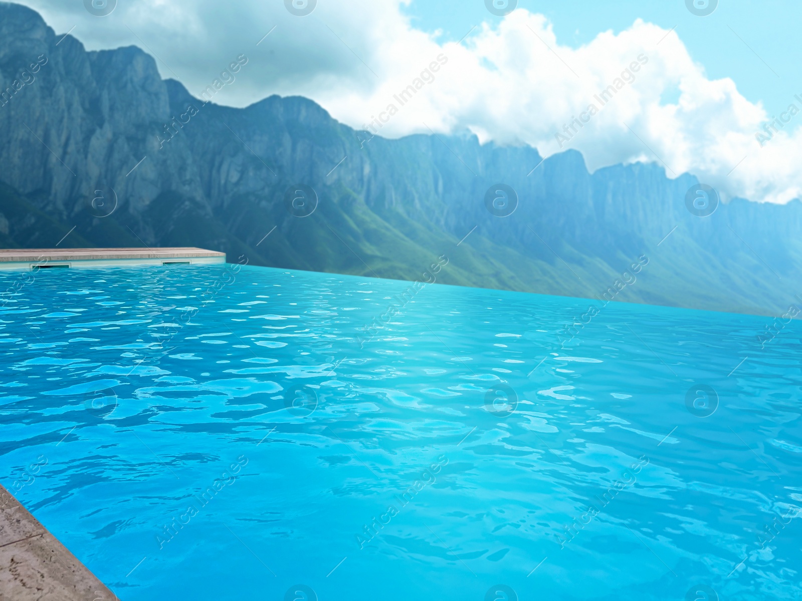 Image of Outdoor swimming pool at luxury resort with beautiful view of mountains