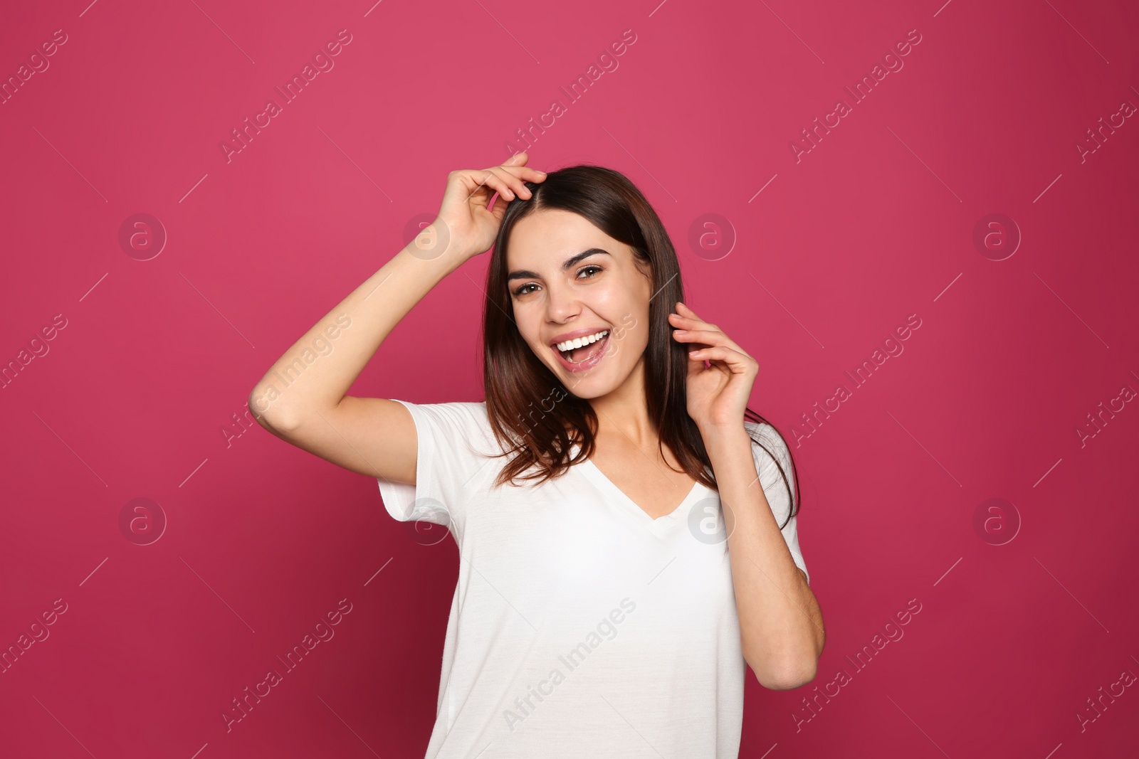 Photo of Portrait of young woman laughing on color background