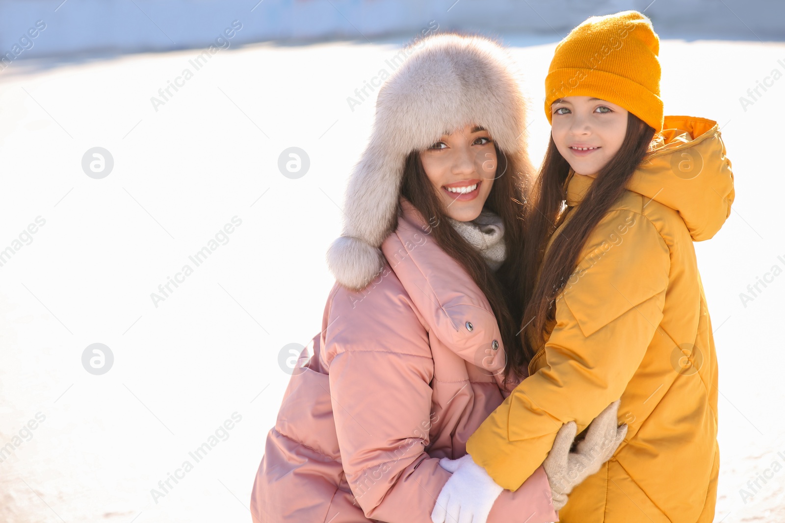 Photo of Mother and daughter spending time together at outdoor ice skating rink