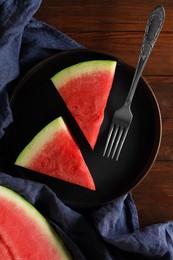 Sliced fresh juicy watermelon served on wooden table, flat lay