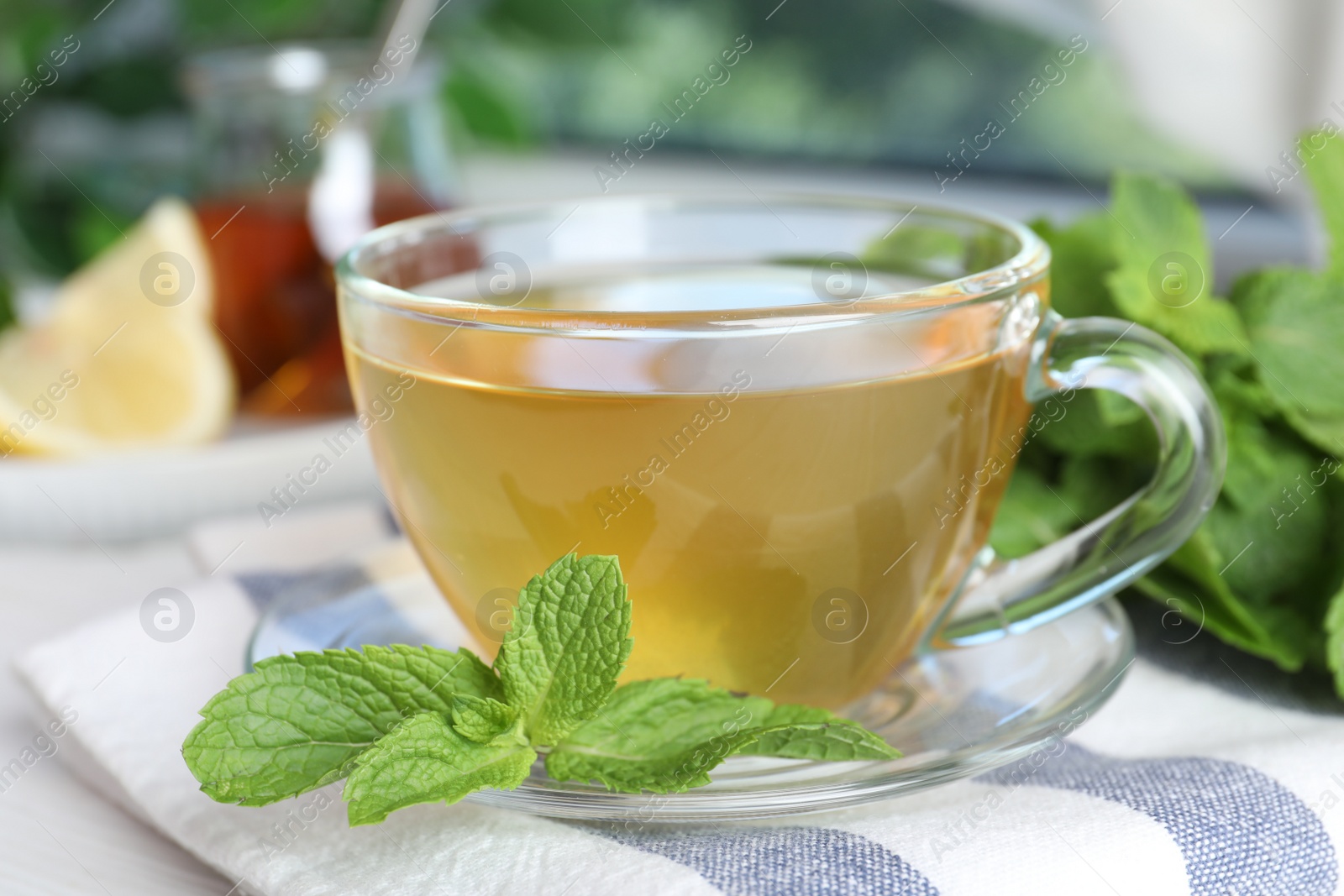 Photo of Fresh green tea with mint leaves on table, closeup