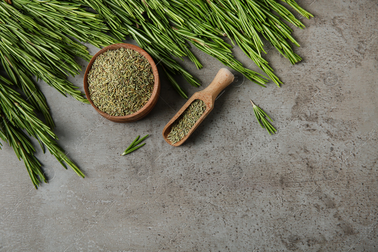 Photo of Dried rosemary and fresh twigs on grey background, flat lay. Space for text