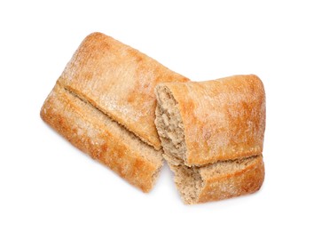 Cut delicious ciabatta on white background, top view