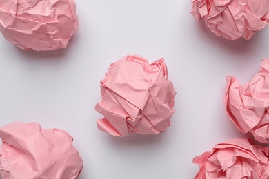 Photo of Color crumpled sheets of paper on white background, top view