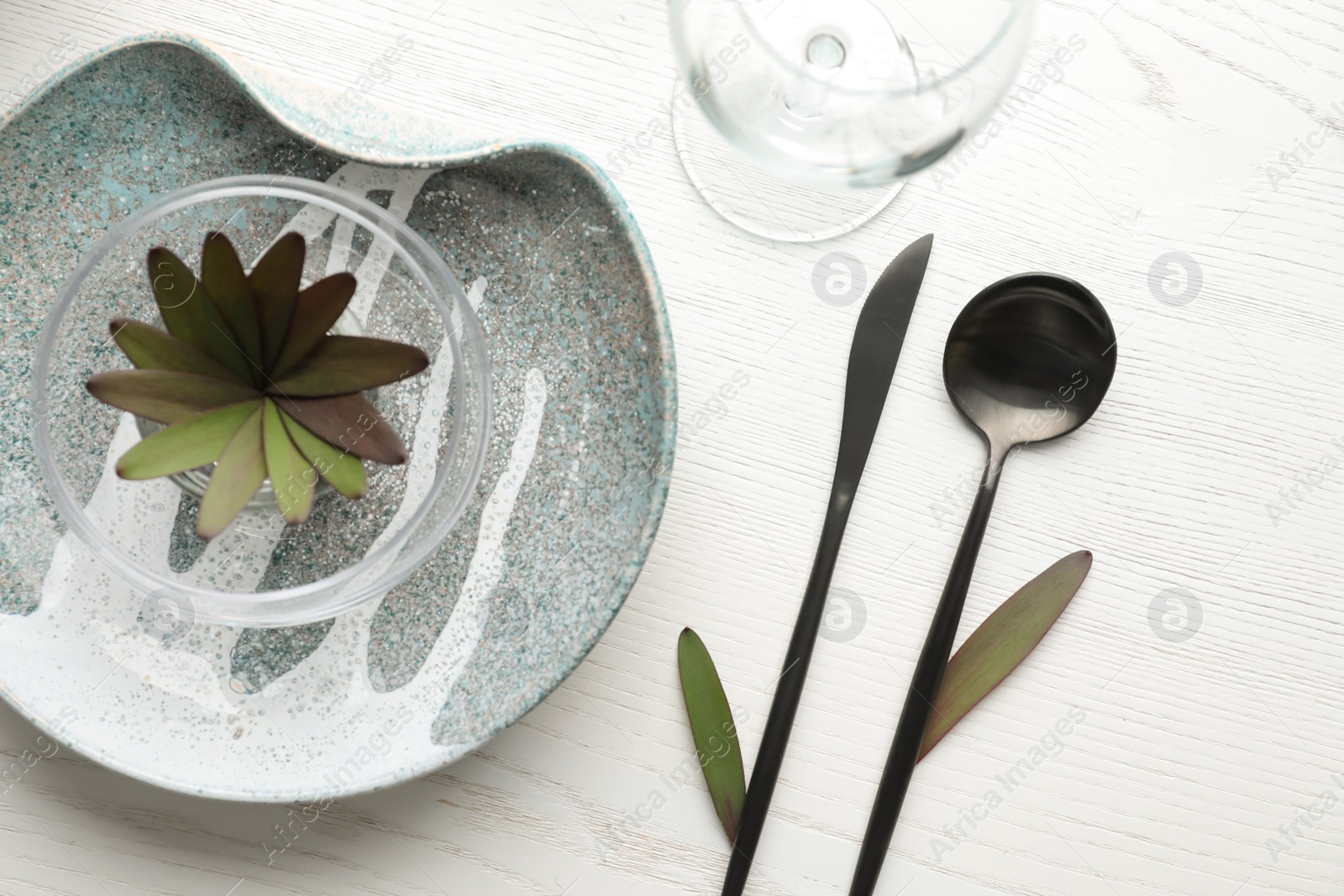 Photo of Elegant table setting with floral decor on white wooden background, flat lay