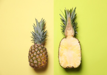 Photo of Cut and whole pineapples on color background, flat lay